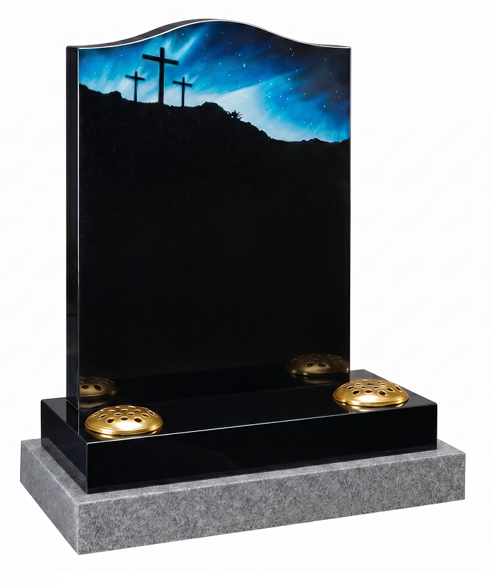 Black granite headstone with engraved Calvary scene showing three crosses on a hill under a starry night sky