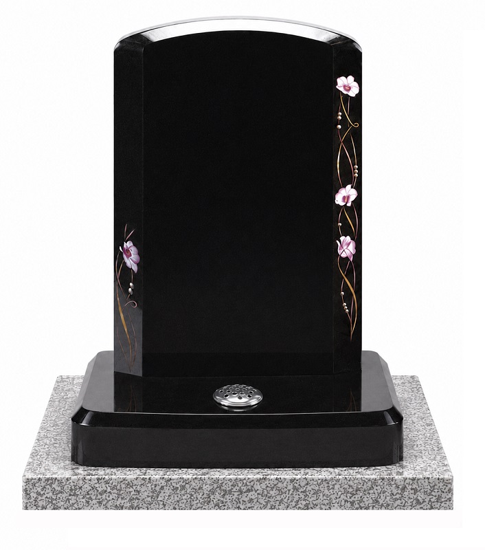 Polished black granite memorial headstone with orchid flower design and rectangular light grey granite base