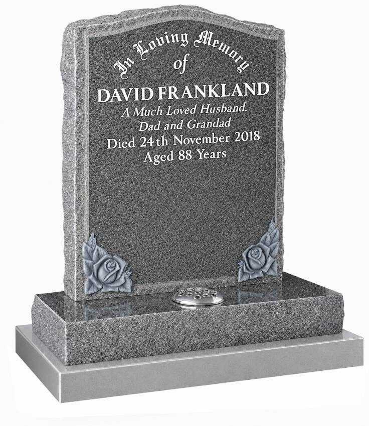 Dark grey granite memorial headstone with pitched edges, white lettering and silver rose corner design